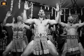 In Berkhamsted, a black-and-white action shot captures Māori dancers performing at a tipi wedding reception.